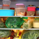Refrigerator full of containers, produce bags, and condiments